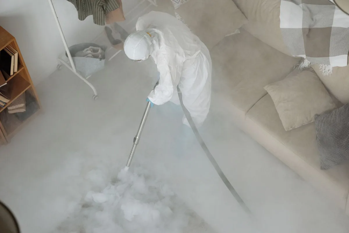 Biohazard cleanup technician in protective equipment, Holland, MI